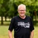 Dr Rob Derrick stands with trees and grass in the background.
